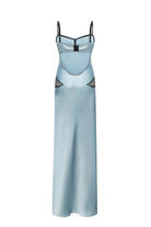 A light blue satin slip Daphne dress with thin black spaghetti straps and embroidered black feather details on the hips, shown against a plain white background, back view