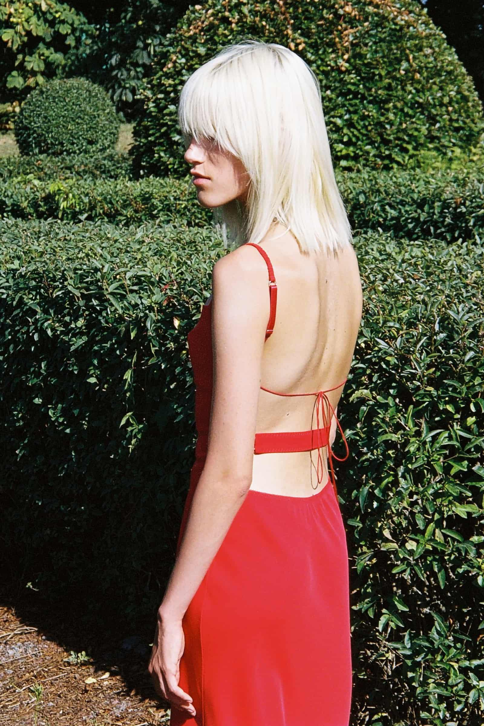 Model in red Yelena dress side view