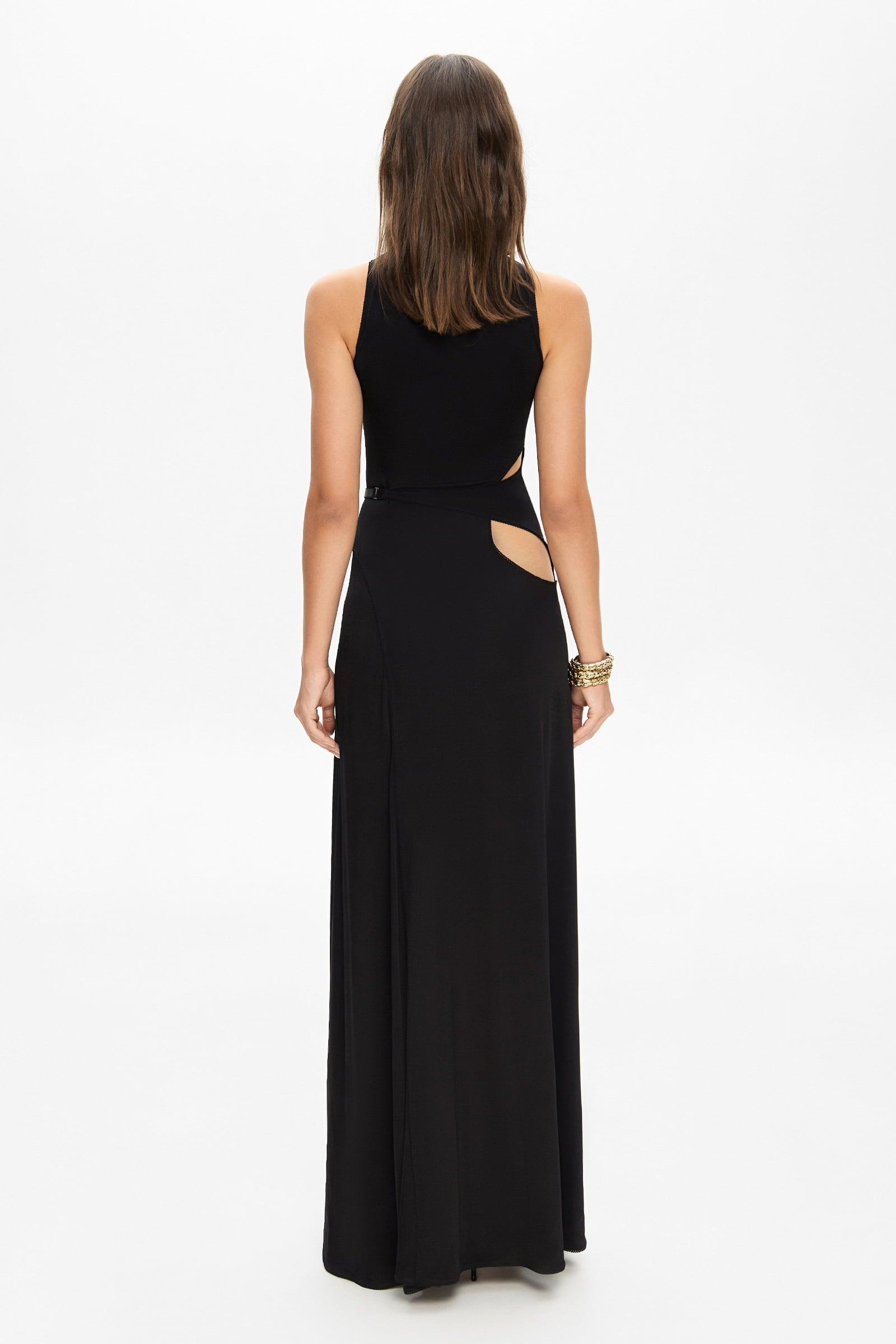 Model in knitted maxi silhouette Abelia dress with cuts on waist back view