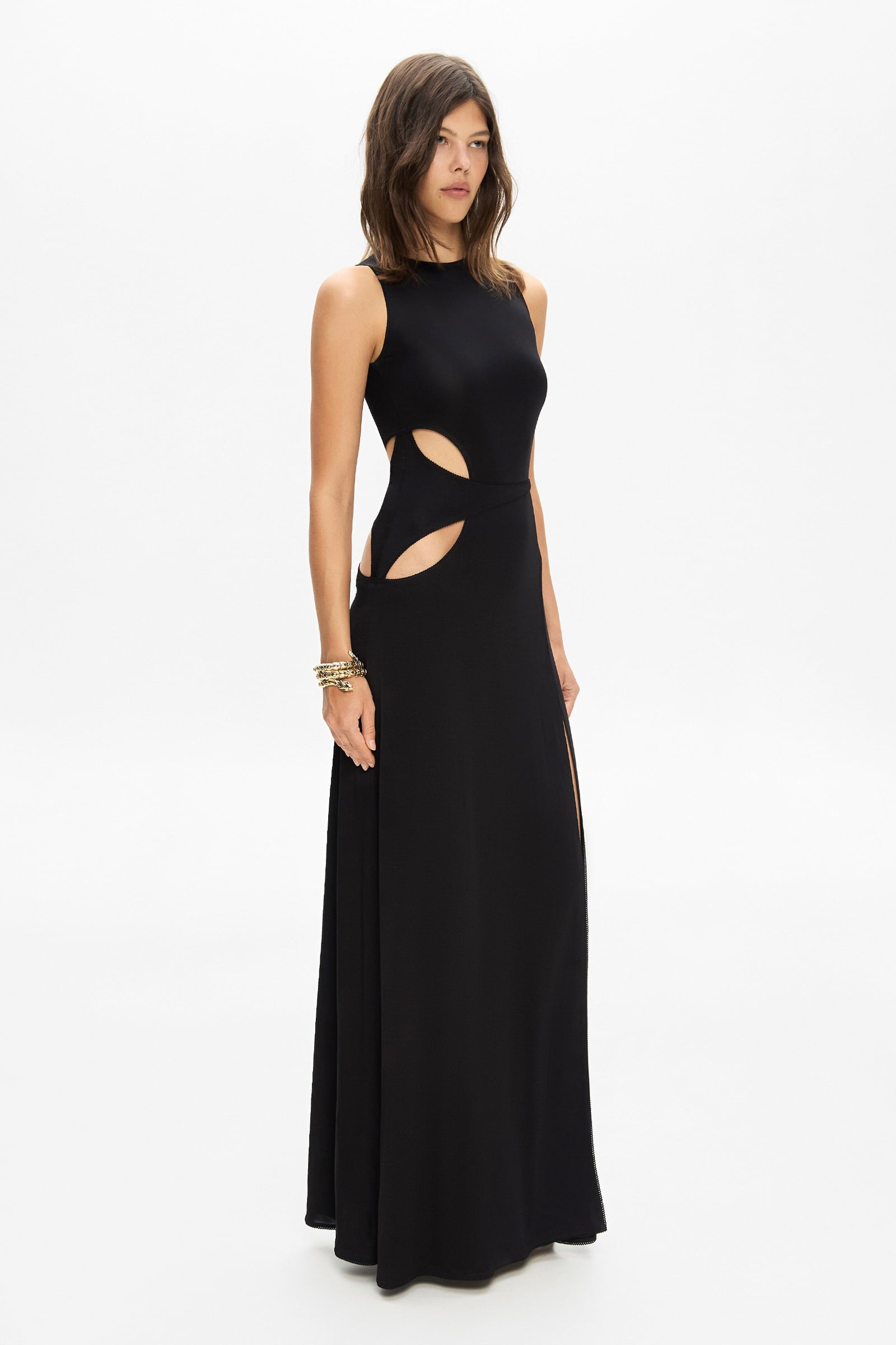 Model in knitted maxi silhouette Abelia dress with cuts on waist side view