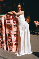 Model in knitted maxi silhouette Arpha dress with wide skirt front view