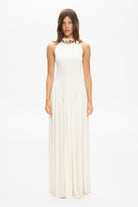 Model in knitted maxi silhouette Arpha dress with wide skirt front view