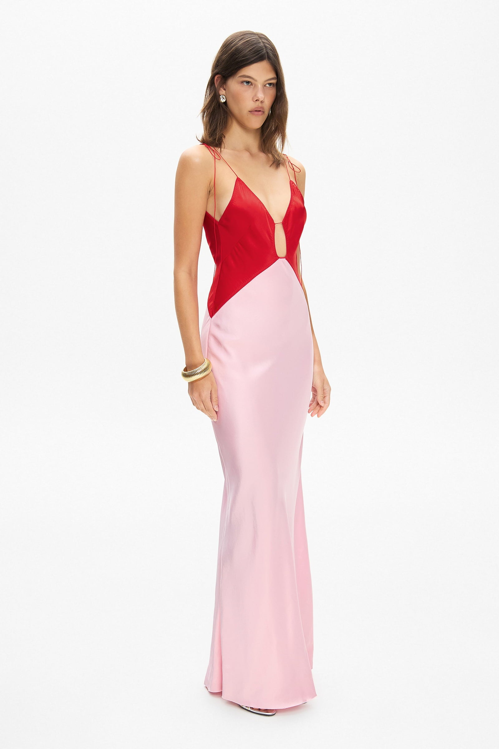 Model in maxi contrast Terrin dress on straps with a cut on the bodice side view