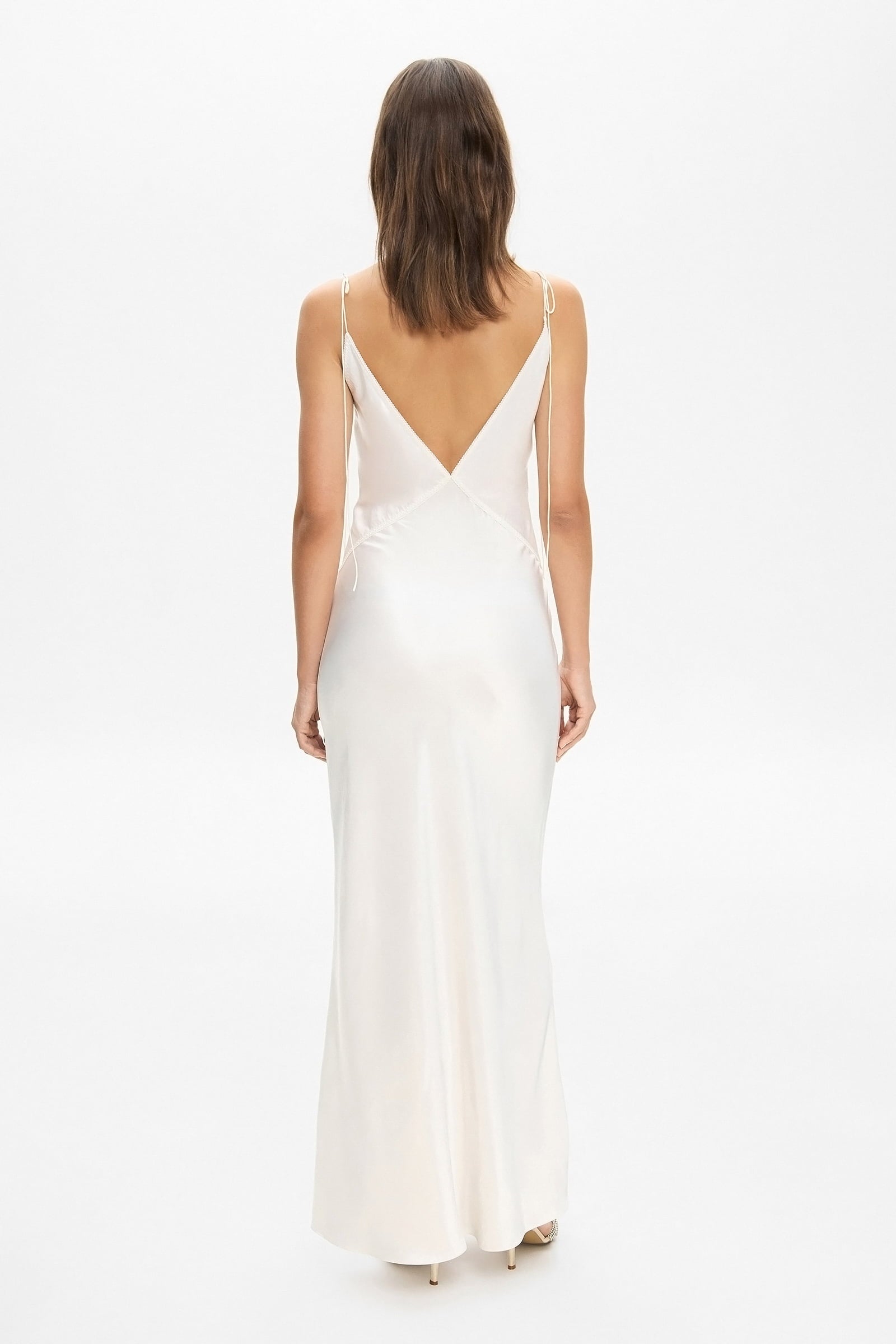 Model in maxi Sophisticated Terrin dress on straps with decored embroidery and a cut on the bodice back view