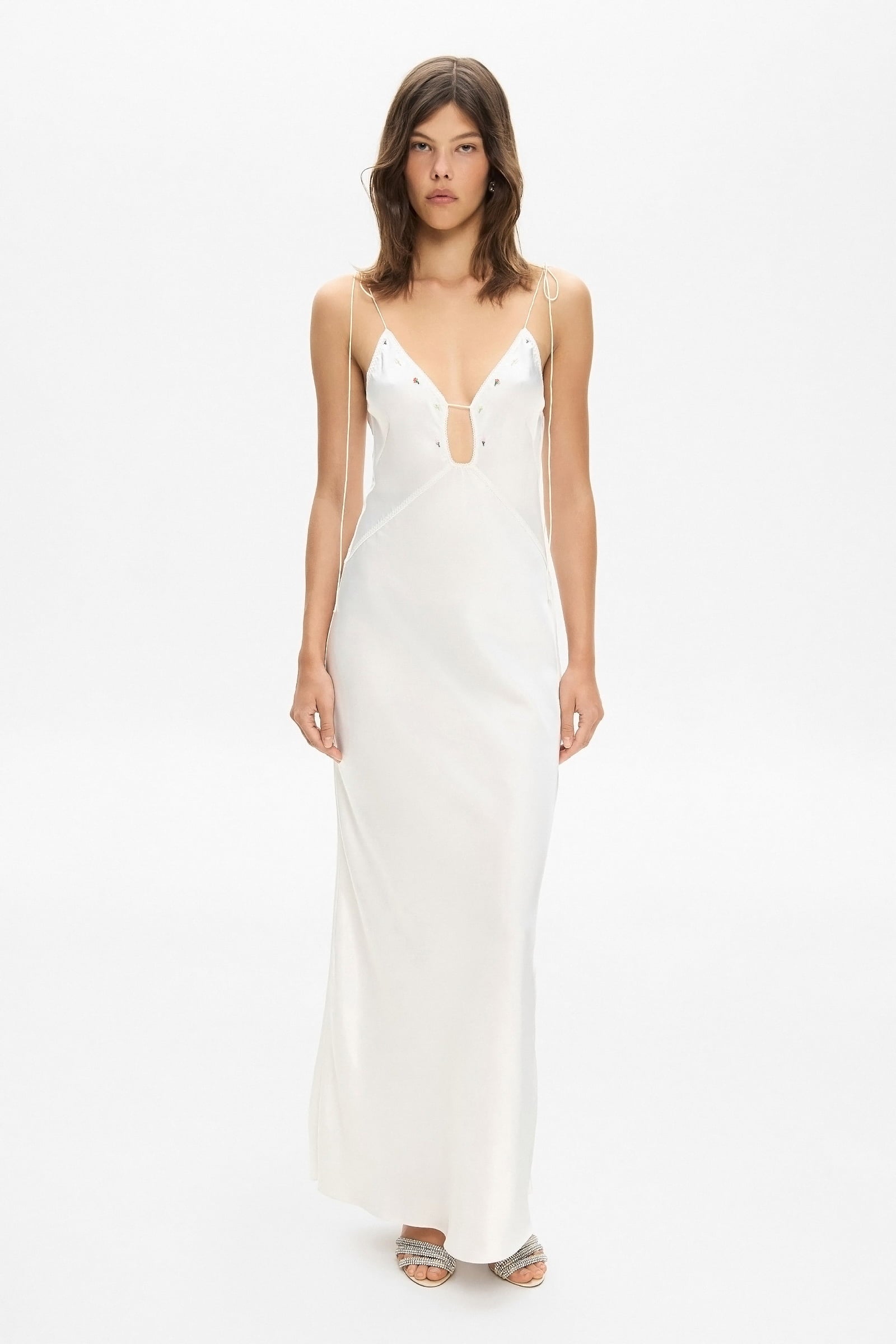 Model in maxi Sophisticated Terrin dress on straps with decored embroidery and a cut on the bodice front view