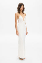 Model in maxi Sophisticated Terrin dress on straps with decored embroidery and a cut on the bodice side view