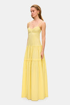 Model in bustier style bodice maxi Yulitta dress with a wide skirt side view