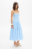 Model in bustier style bodice midi Calliope dress with a wide skirt side view