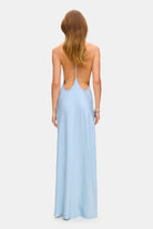 Model in open back Justina maxi dress with open shoulders back view