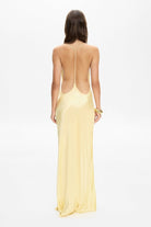 Model in open back Justina maxi dress with open shoulders back view