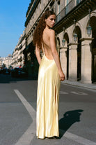 Model in open back Justina maxi dress with open shoulders back view