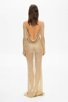 Model in long sleeved maxi silhouette Goldie dress with a drapery on back back view