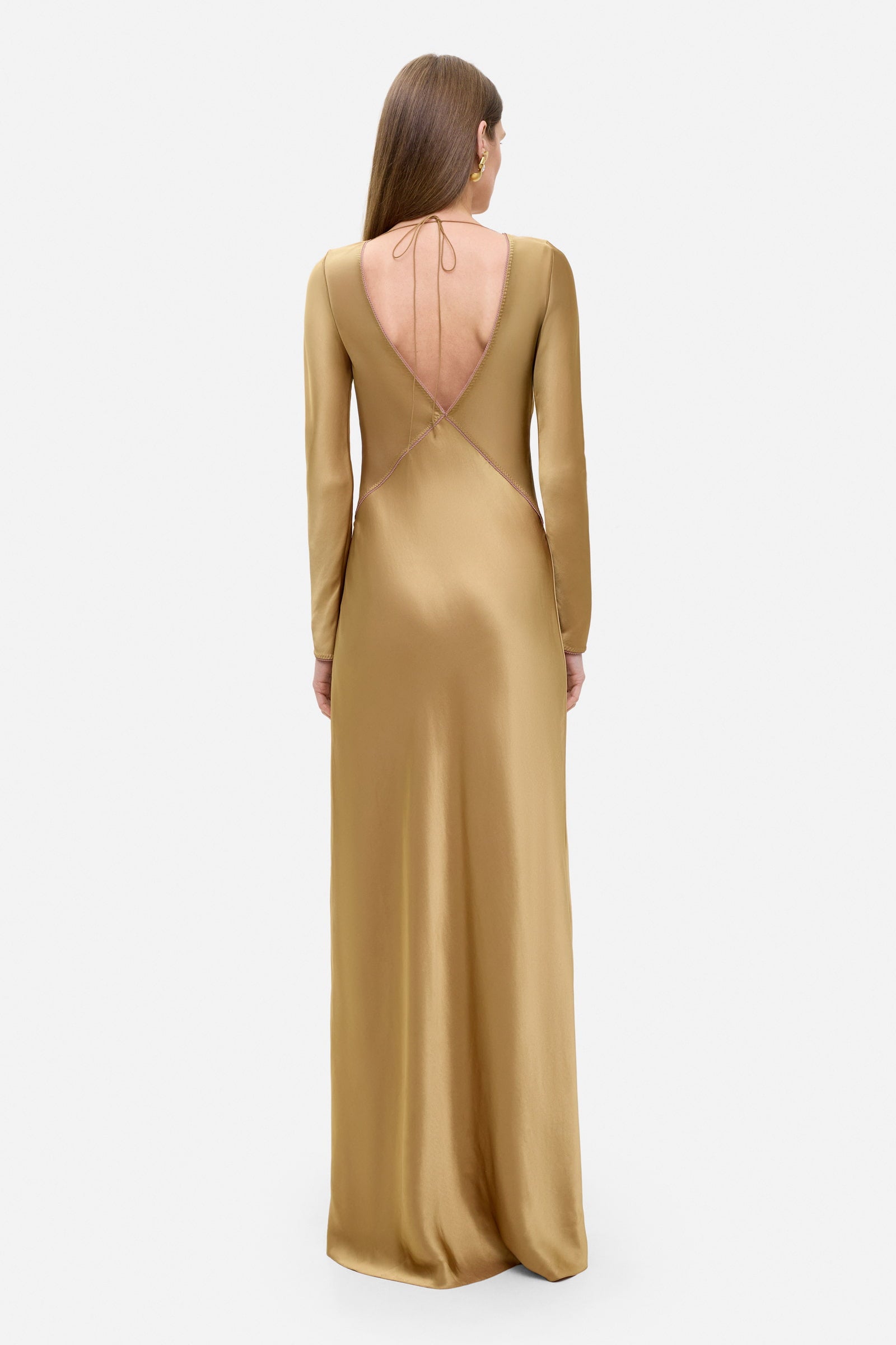 Model in long-sleeved Celeste maxi dress with a cut on the top back view