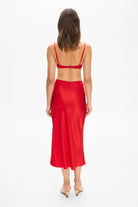 Model in Champaca midi skirt with stitches on hips back view