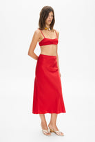 Model in Champaca midi skirt with stitches on hips side view