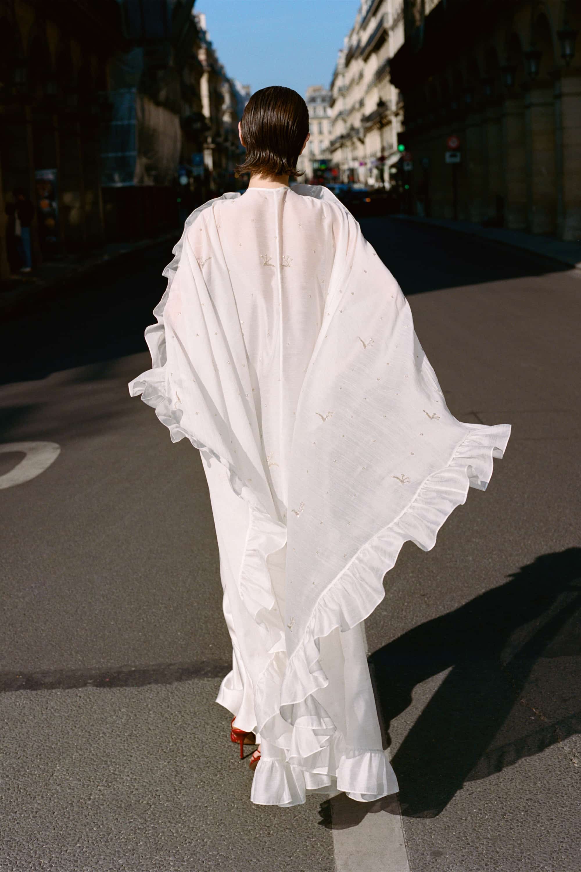 Model in Bernadette cape with embroidery handmade lookbook back view