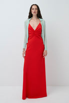Woman wearing a coral Eliana dress with a mint Ensley cardigan on a white background, front view