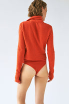 Model in orange Eliana cardigan