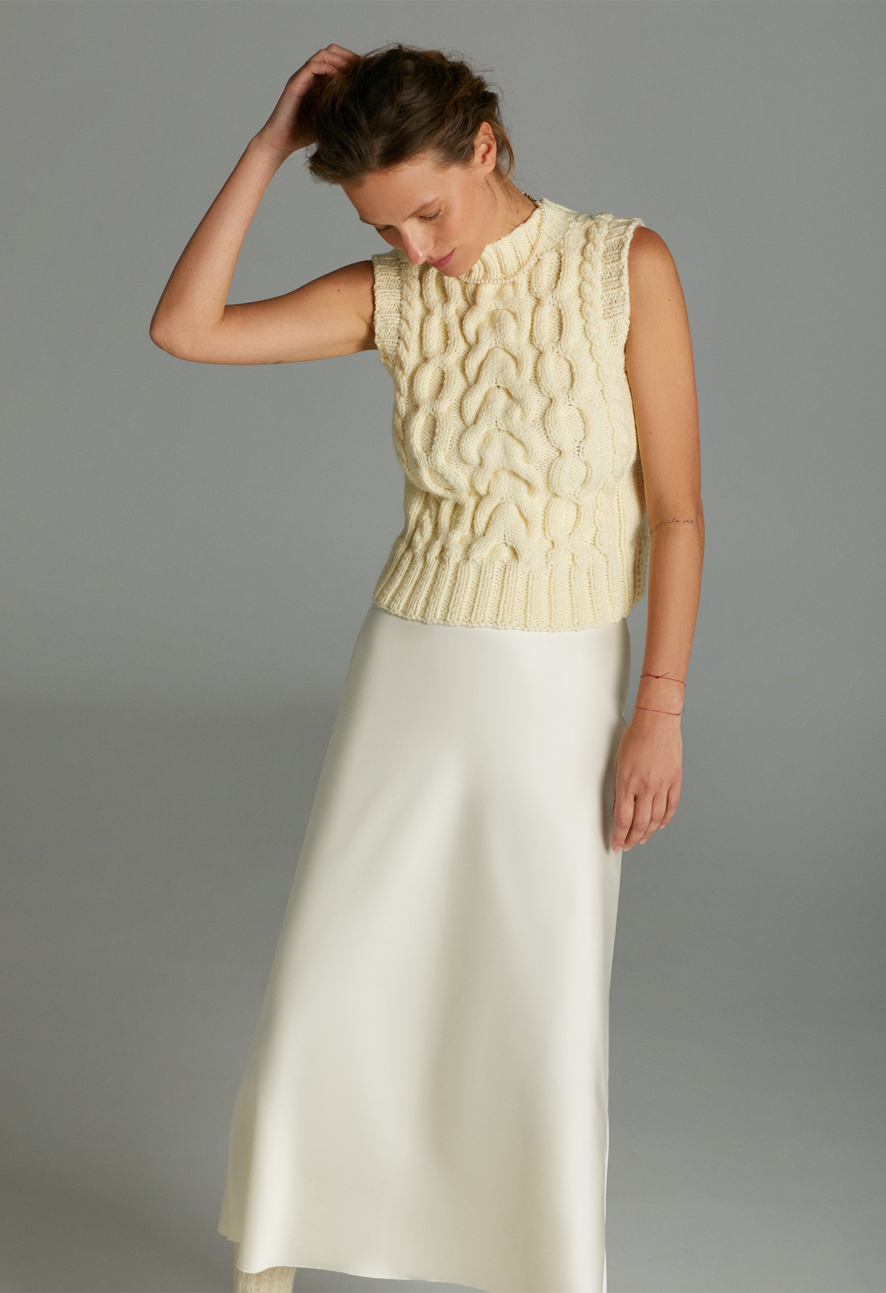 Model in Cream hand knitted vest