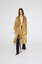 Model in golden Eiffel coat