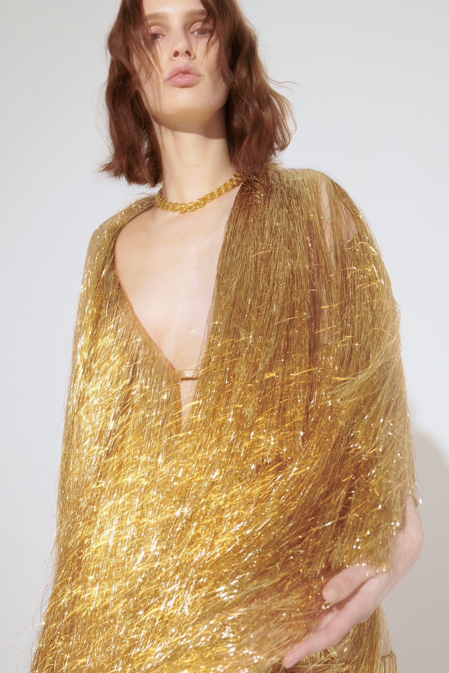 Model in golden Eiffel coat