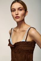 Model in brown Margarita top