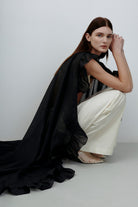 Model in black Bernadette cape